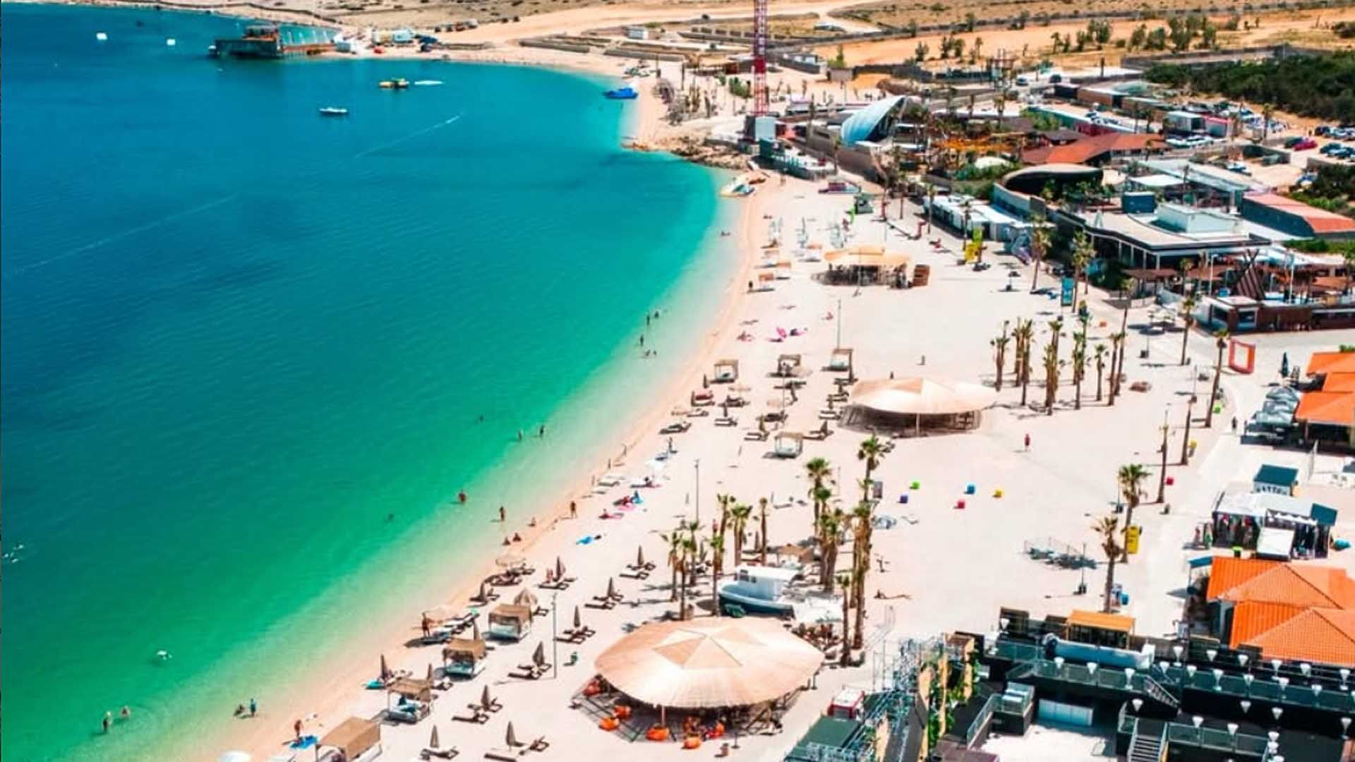 Aerial view of Zrće Beach near Novalja: turquoise sea, pebble beach and the open-air clubs